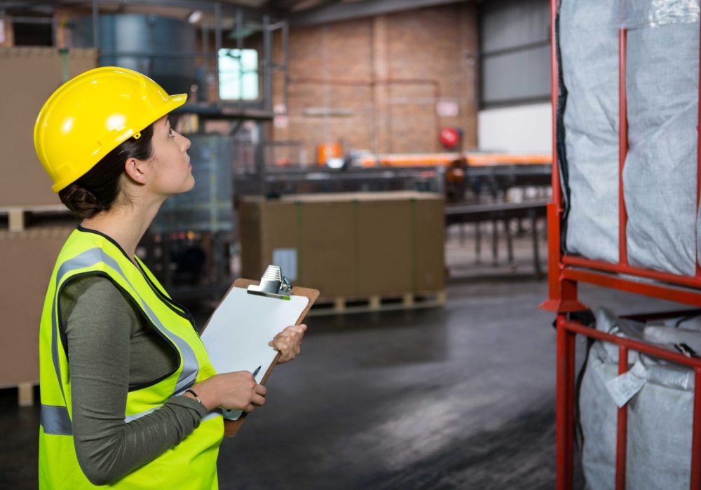 compressed_confident-female-worker-examining-products-warehouse